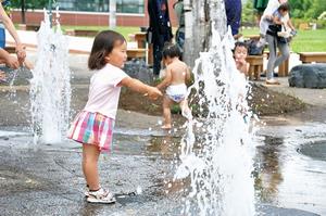噴水で遊ぶ子供の写真